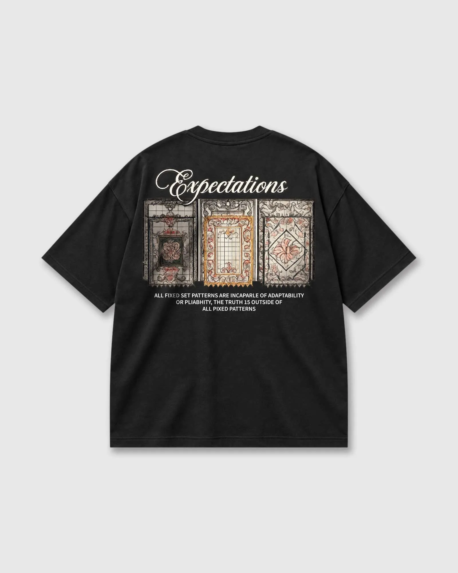 Back of a black Outflee Framed Expectations drop shoulder T-shirt with large script lettering, three ornate vintage frame artworks and statement typography.