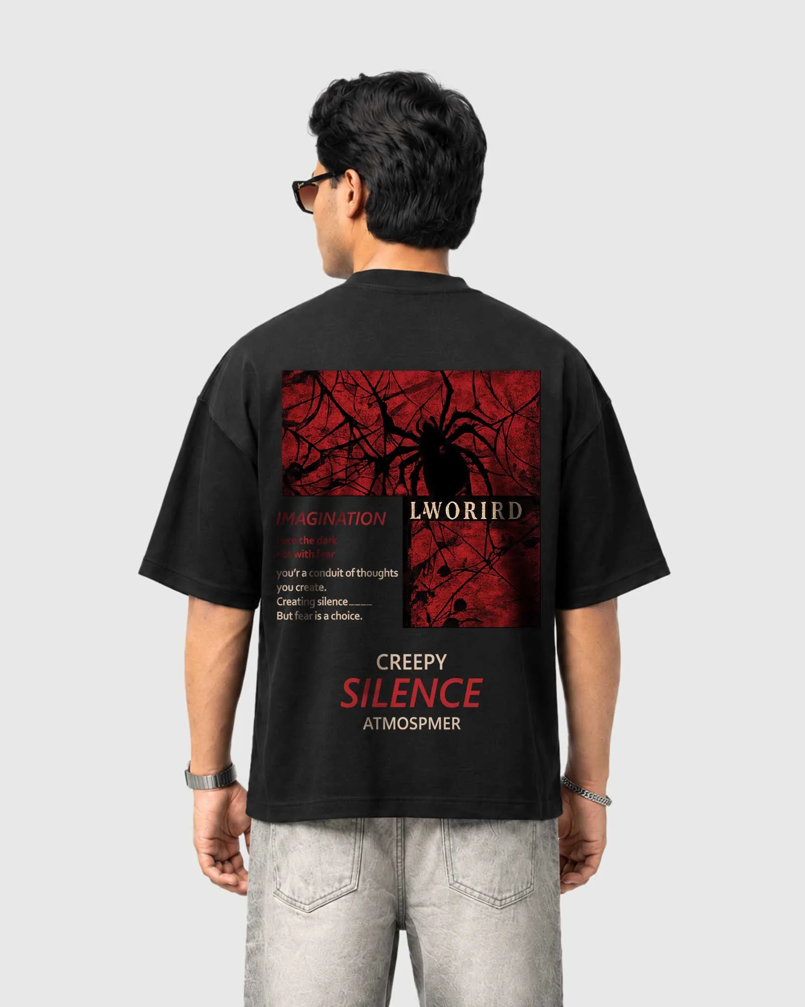 Model wearing the black Outflee Creeping Silence drop shoulder T-shirt, back view showing the red-and-black spider-web artwork and creepy silence typography.
