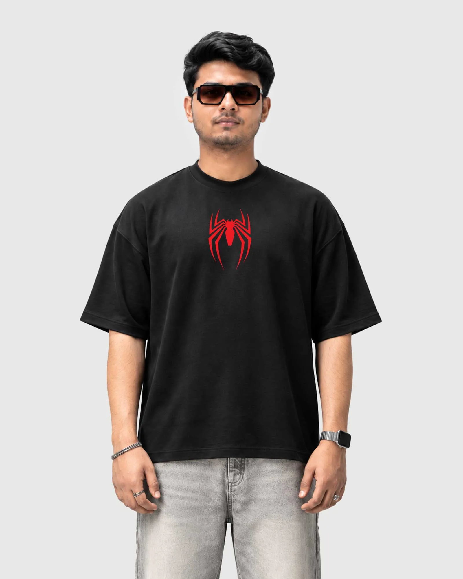 Model wearing the black Outflee Creeping Silence drop shoulder T-shirt, front view showing the bold red spider chest emblem.