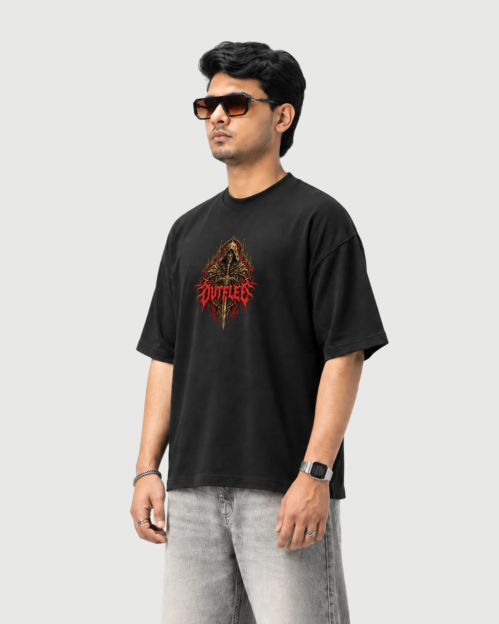 Three-quarter view of a model wearing the black Outflee Crimson Warden drop shoulder T-shirt, showing the relaxed fit and gothic warrior chest print.