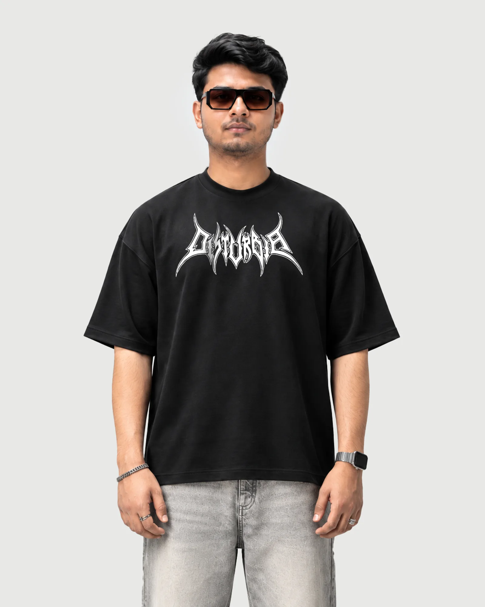 Model wearing the black Outflee Skullbound drop shoulder T-shirt, front view showing the white gothic Outflee chest logo.