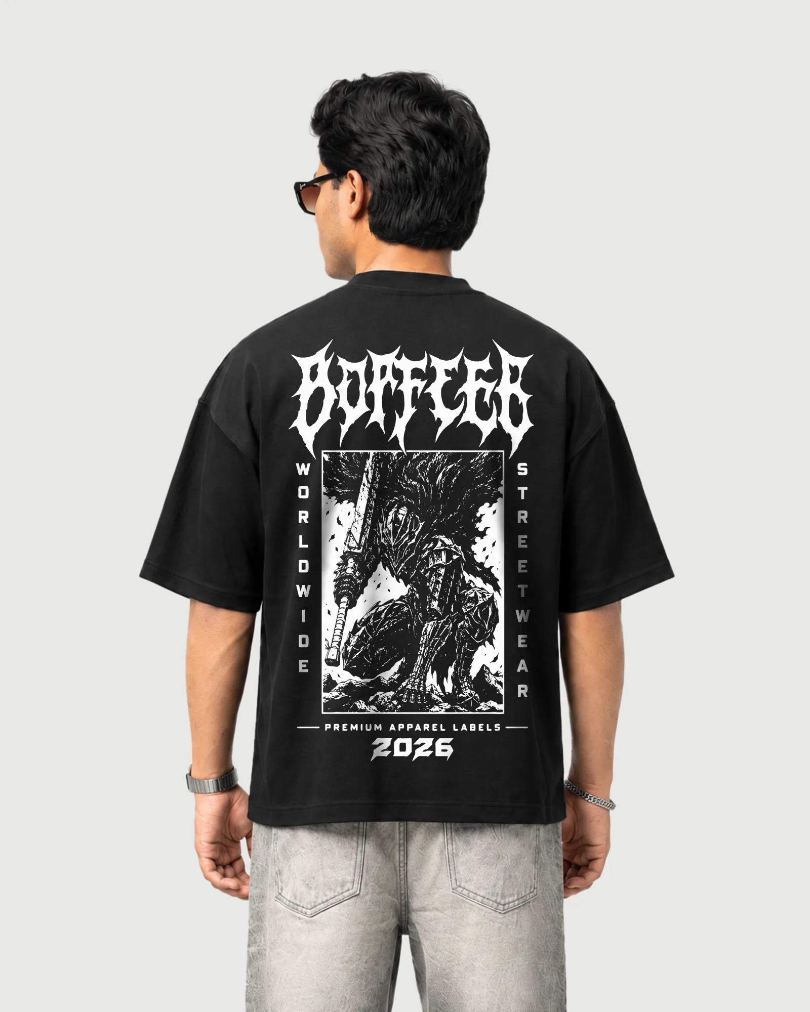 Model wearing the black Outflee Shadow Ronin drop shoulder T-shirt, back view showing the large armored warrior and monochrome graphic artwork.