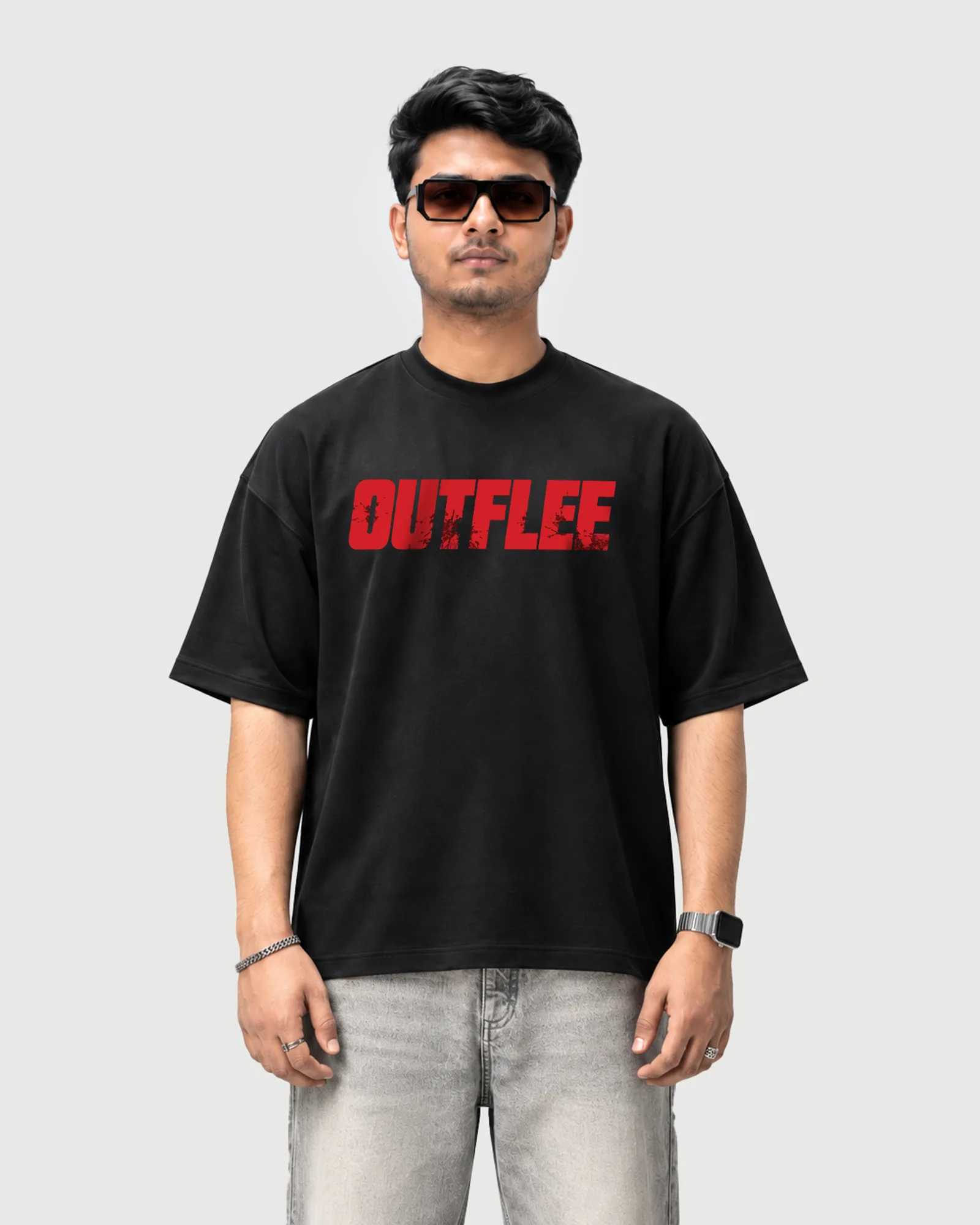 Model wearing the black Outflee Same Streets Different Minds drop shoulder T-shirt, front view showing the large distressed red Outflee chest print.
